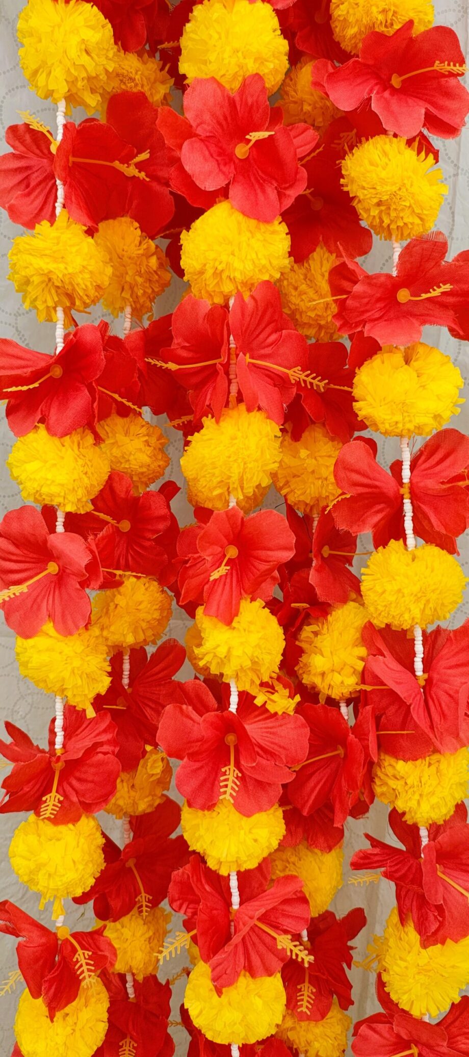 Pair of Yellow Marigold Garlands Studded with Red Hibiscus