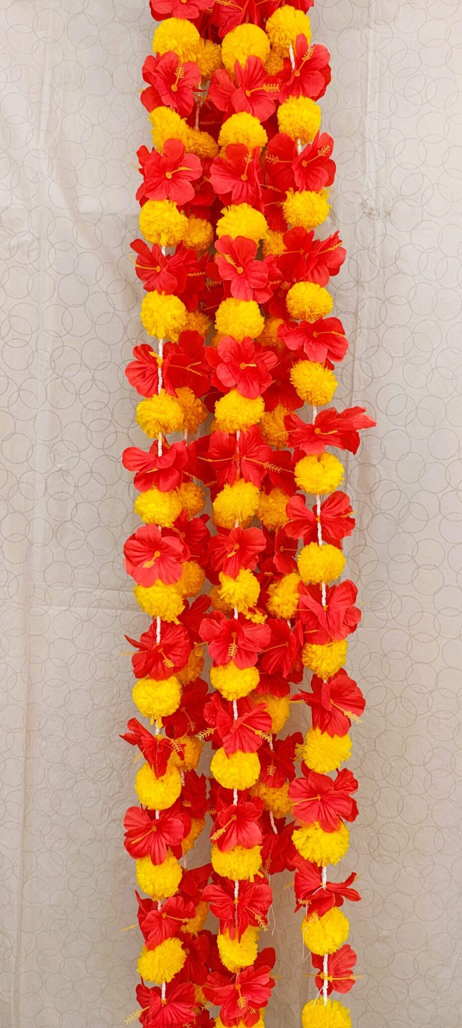 Pair of Yellow Marigold Garlands Studded with Red Hibiscus